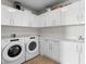 Well-equipped laundry room with modern washer and dryer, ample cabinet space, and sleek countertops at 301 1St S St # 1601, St Petersburg, FL 33701