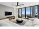 Contemporary living room with stylish furniture, ceiling fan, and floor-to-ceiling windows with a water view at 301 1St S St # 1601, St Petersburg, FL 33701
