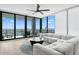 Bright living room with floor-to-ceiling windows offering stunning views of the water and a modern ceiling fan at 301 1St S St # 1601, St Petersburg, FL 33701