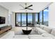 Elegant living room with modern furnishings, ceiling fan, and sliding glass doors leading to a balcony at 301 1St S St # 1601, St Petersburg, FL 33701