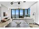 Bright open-concept living room boasts modern decor, expansive windows, and a stunning water view at 301 1St S St # 1601, St Petersburg, FL 33701