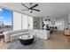 Cozy living room featuring a modern sectional sofa, round coffee table, and views into the kitchen and dining area at 301 1St S St # 1601, St Petersburg, FL 33701