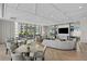 Bright lounge area with modern furnishings, herringbone floors, and floor-to-ceiling windows overlooking the city and water at 301 1St S St # 1601, St Petersburg, FL 33701