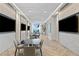 Bright lounge area with multiple TVs, stylish seating, herringbone floors, and floor-to-ceiling windows at 301 1St S St # 1601, St Petersburg, FL 33701