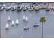 Picturesque marina scene with sailboats and powerboats sailing on calm waters near a palm-lined shore and docked yachts at 301 1St S St # 1601, St Petersburg, FL 33701