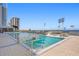 Inviting outdoor pool and spa deck area with luxurious lounge chairs for sunbathing and relaxation at 301 1St S St # 1601, St Petersburg, FL 33701