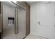 Stainless steel refrigerator featuring water and ice dispenser, alongside matching wood cabinetry and a white door at 301 1St S St # 1601, St Petersburg, FL 33701