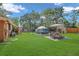 Spacious backyard featuring green grass, an in-ground hot tub, and a patio area at 3106 E Diana St, Tampa, FL 33610