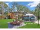 Inviting backyard with seating area, complete with an above-ground pool and a shaded patio space at 3106 E Diana St, Tampa, FL 33610