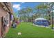 Backyard features a large grassy area, above-ground pool with cover, EV charger, and mature trees at 3106 E Diana St, Tampa, FL 33610