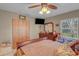 Comfortable bedroom with dresser, large window, ceiling fan and spacious closet at 3106 E Diana St, Tampa, FL 33610