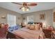 Cozy bedroom featuring a ceiling fan, bedside tables, and a comfortable bed at 3106 E Diana St, Tampa, FL 33610