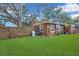 Home's exterior features a well-maintained yard and gated fence for added privacy at 3106 E Diana St, Tampa, FL 33610