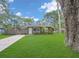 Charming home with a well-maintained lawn, a concrete driveway, and a traditional American flag at 3106 E Diana St, Tampa, FL 33610