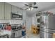 Modern kitchen boasts stainless steel appliances, updated cabinets, and an adjacent dining area for convenience at 3106 E Diana St, Tampa, FL 33610