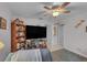 Bright living room features a ceiling fan and built-in shelving, offering a comfortable gathering space at 3106 E Diana St, Tampa, FL 33610