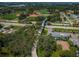 Aerial view of the community, with a pedestrian bridge leading to well-maintained baseball fields and lush green trees at 3150 San Jose St, Clearwater, FL 33759