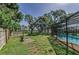 Expansive backyard features mature trees, a screened pool, and room to roam, providing a private oasis at 3150 San Jose St, Clearwater, FL 33759