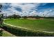 Well-maintained baseball field featuring lush green grass and clear blue skies, framed by trees and a green hedge at 3150 San Jose St, Clearwater, FL 33759