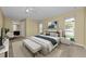Bright bedroom showcasing neutral walls, carpet, windows, a ceiling fan, and a luxurious bed with stylish decor at 3150 San Jose St, Clearwater, FL 33759