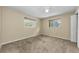Bright bedroom with plush carpeting, two windows, and ceiling fan at 3150 San Jose St, Clearwater, FL 33759