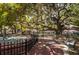Wide shot of a community park featuring mature trees, benches, and a statue in a serene setting at 3150 San Jose St, Clearwater, FL 33759