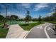 Paved community walking path and basketball court with benches for relaxing and enjoying the outdoors at 3150 San Jose St, Clearwater, FL 33759