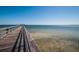 Wide angle image of a long wooden community pier extending into the calm water at 3150 San Jose St, Clearwater, FL 33759