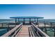 Detailed shot of the community pier with a covered seating area at the end for waterfront views at 3150 San Jose St, Clearwater, FL 33759