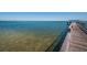 Image of the community pier from afar with calm ocean waters at 3150 San Jose St, Clearwater, FL 33759