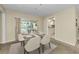 Bright dining area with sliding glass doors overlooking the pool and an adjacent kitchen at 3150 San Jose St, Clearwater, FL 33759