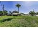 Sprawling single story home features a lush lawn, mature landscaping, and a welcoming entrance at 3150 San Jose St, Clearwater, FL 33759