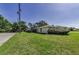 Exterior side view of the home showcasing the yard and landscaping at 3150 San Jose St, Clearwater, FL 33759