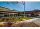 Exterior view of a building with an American flag, landscaping and walkway at 3150 San Jose St, Clearwater, FL 33759