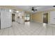 Open kitchen with white cabinetry and appliances leading to the outdoor patio at 3150 San Jose St, Clearwater, FL 33759