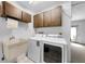 Laundry room with cabinets, utility sink, washer, and dryer at 3150 San Jose St, Clearwater, FL 33759