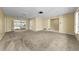 Spacious living room with neutral carpet and a view of the screened-in pool area at 3150 San Jose St, Clearwater, FL 33759