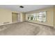 Open living room with large window and neutral carpet at 3150 San Jose St, Clearwater, FL 33759