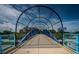 Inviting pedestrian bridge with sturdy blue railings, secure black fencing, and a scenic view of McMullen Booth Rd at 3150 San Jose St, Clearwater, FL 33759