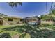 Screened pool with lush green lawn and connection to house, offering privacy and relaxation at 3150 San Jose St, Clearwater, FL 33759