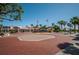 Safety Harbor resort entrance with a brick roundabout, palm trees, and the American flag at 3150 San Jose St, Clearwater, FL 33759