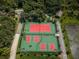 Aerial view of the community tennis courts and lush landscaping that offers a vibrant space for sports and recreation at 3150 San Jose St, Clearwater, FL 33759