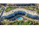 Aerial view of blue condo with a pool, landscaping, and parking offers scenic and convenient living at 3315 58Th S Ave # 421, St Petersburg, FL 33712
