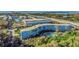 Aerial view of a blue condo building with a pool, manicured landscaping, and convenient parking at 3315 58Th S Ave # 421, St Petersburg, FL 33712