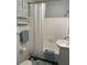 Bathroom with a tub and shower, tiled walls, decorative towels, and two matching art prints at 3315 58Th S Ave # 421, St Petersburg, FL 33712