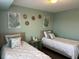 Inviting bedroom featuring twin beds, decorative pillows, wall art, and a calm, coordinated color scheme at 3315 58Th S Ave # 421, St Petersburg, FL 33712