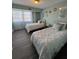 Charming bedroom with twin beds, featuring a light green color scheme, and a window with sheer curtains at 3315 58Th S Ave # 421, St Petersburg, FL 33712