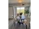 Bright dining area featuring neutral tones, a round table, and sliding glass doors to the balcony at 3315 58Th S Ave # 421, St Petersburg, FL 33712