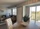 Well-lit dining area with seating, balcony access, and an open view to the adjacent living room at 3315 58Th S Ave # 421, St Petersburg, FL 33712