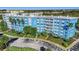 Five-story condo building in an urban area, with blue accents, palm trees, and private balconies at 3315 58Th S Ave # 421, St Petersburg, FL 33712